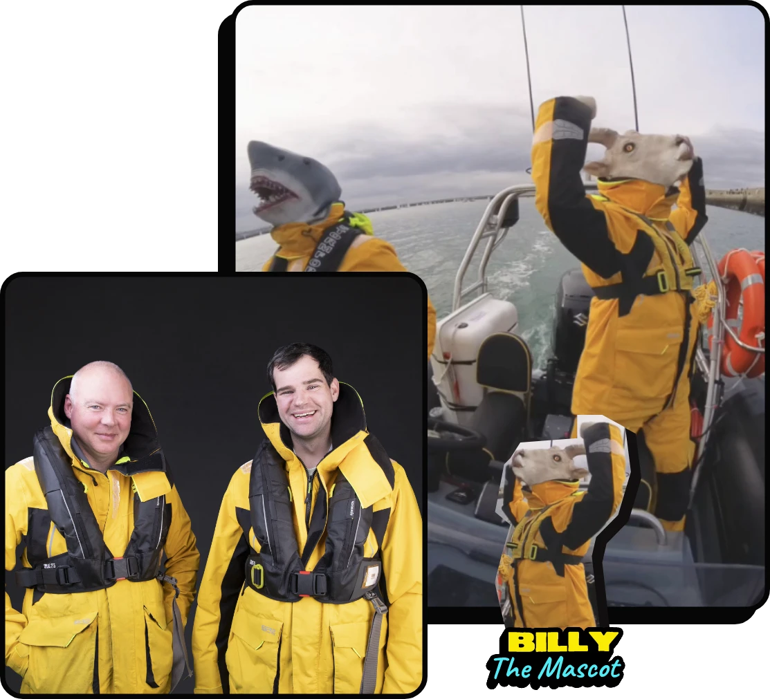 A person wearing a shark mascot head and yellow waterproof gear celebrates on a boat; inset shows two men in similar yellow gear smiling against a black background. Text reads: "BILLY The Mascot.