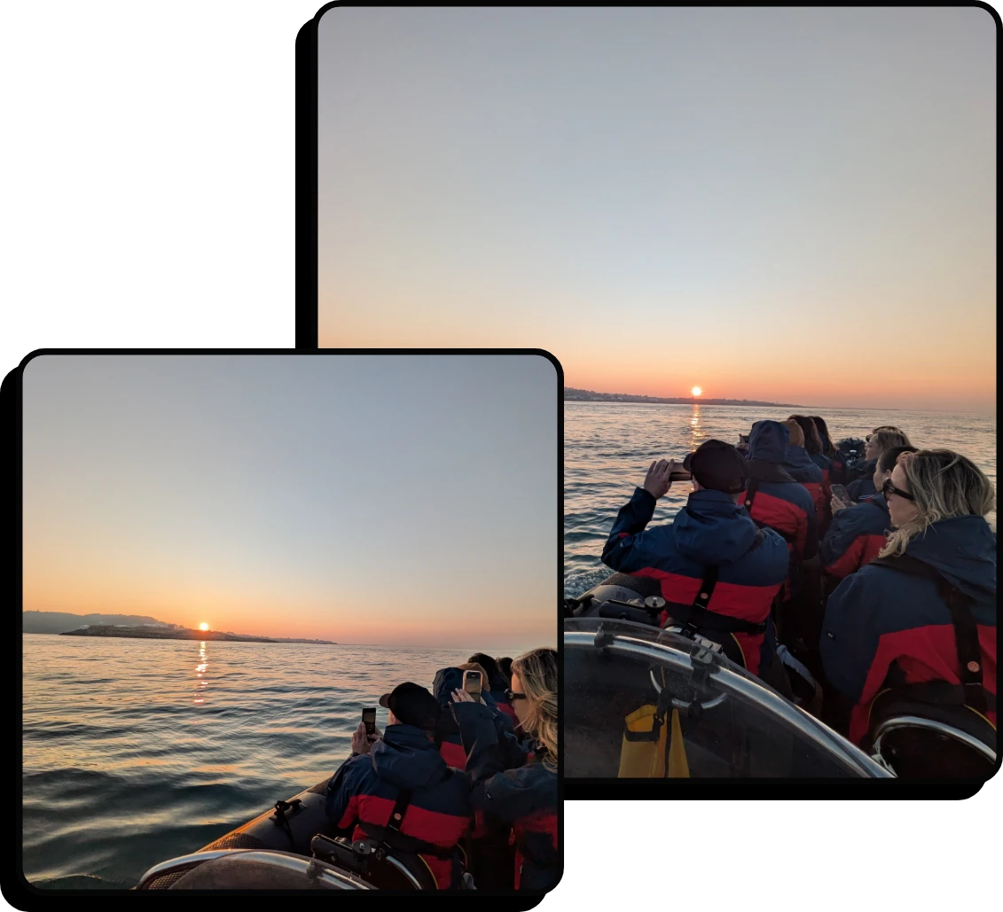 Two photos show people in a boat wearing jackets, watching and photographing a sunset over calm water, with the sun low on the horizon and a clear sky.